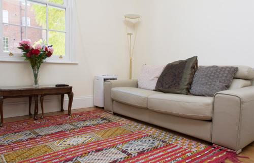 a living room with a couch and a table at Dale Street Apartments Suite in Leamington Spa
