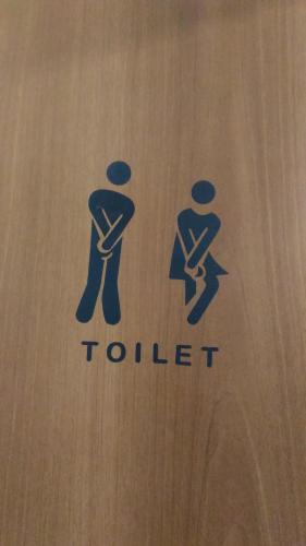 a sign for a toilet with two people on it at Sa Sindria in Cagliari