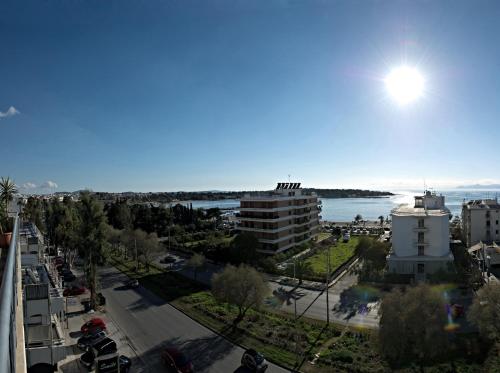 a view of a city with the ocean in the background at Four Seasons Hotel in Athens