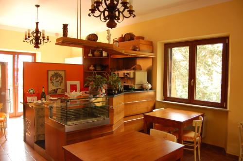 a kitchen with a table and a dining room at Mariani Bed&Breakfast in Castellina in Chianti