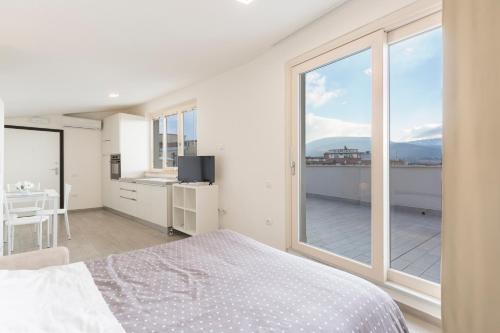 a bedroom with a bed and a large window at Il Nido - Miniattico panoramico by AppartamentiPetrucci in Foligno