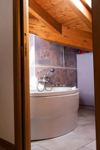 a bath tub with a bike sitting in a bathroom at Romantic Home in Sondalo