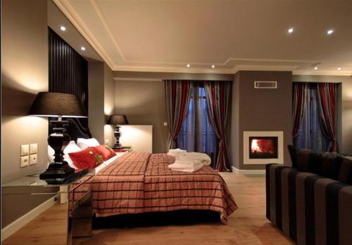 a bedroom with a bed with red pillows at Nerida Boutique Hotel in Dhimitsana