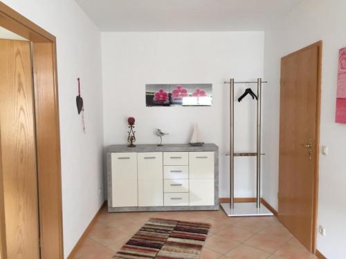 a white bathroom with a sink and a mirror at Ferienwohnung Saarblick in Ockfen