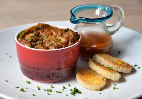 a plate with a bowl of food and a jar of sauce at Casa Culinaria - The Gourmet Inn in Santa Fe