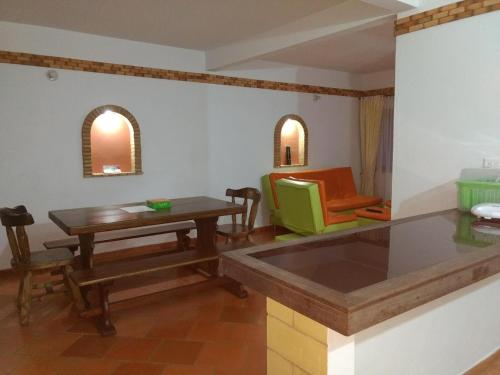 a kitchen with a table and a dining room at Apartahotel La Gran Familia in Villa de Leyva