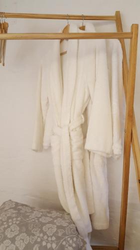 a group of white towels hanging on a rack at Habitaciones Casa de Campo Daymipaz in Mahón