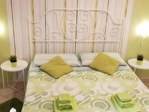 a bed with a metal headboard and two tables at Apartment in Salerno Centro in Salerno