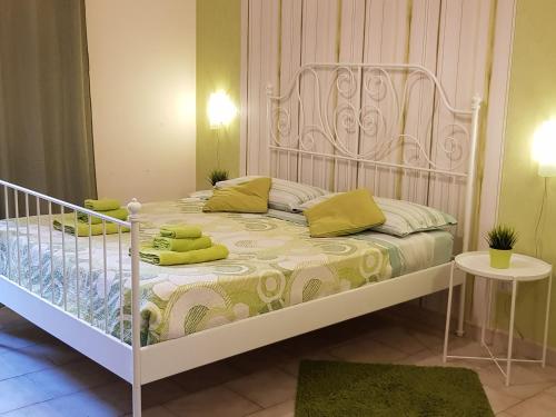 a bedroom with a white bed with yellow pillows at Apartment in Salerno Centro in Salerno