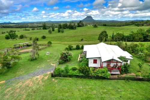 a house with a view of the mountains at Noosa Avalon Farm Cottages in Pomona