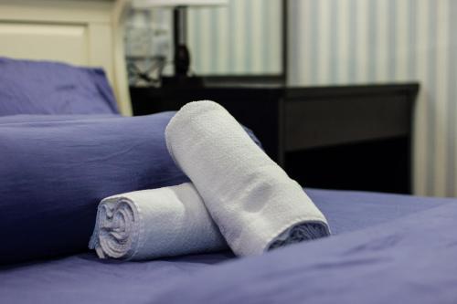 a roll of toilet paper sitting on a bed at USM Designer Dwell in George Town