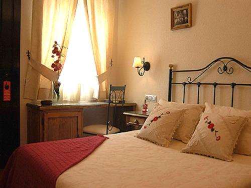 Ένα ή περισσότερα κρεβάτια σε δωμάτιο στο La Posada de Los Comediantes