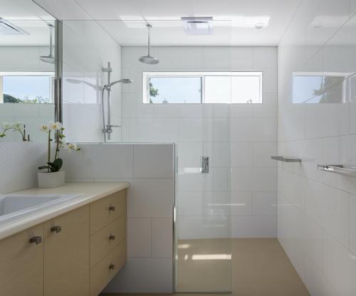 a white bathroom with a shower and a sink at Breakaway on Niblick: newly renovated in Rye