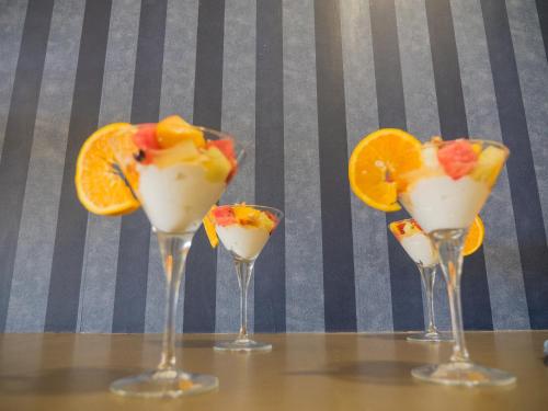 a group of four wine glasses with fruit in them at Paradise Resort in Finikounta