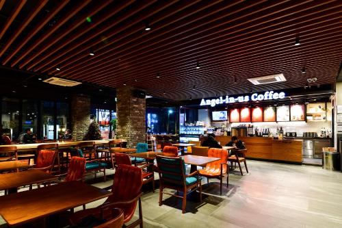 a restaurant with tables and chairs and a bar at Hotel Ritz in Suwon
