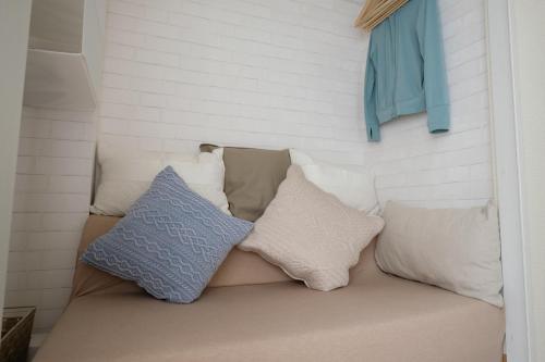 a couch with pillows on it in a room at COCO Nakameguro 201 in Tokyo