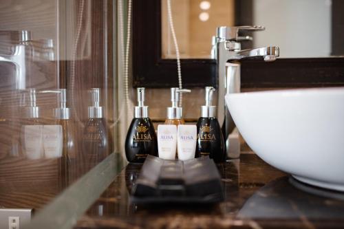 a bathroom with a sink and a counter with a sink at Alisa Hotel & Spa in Hanoi