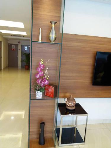 a lobby with a table and vases on shelves at NU Hotel @ KL Sentral in Kuala Lumpur