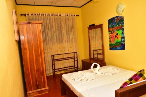 a bedroom with two beds and a window at Our House Hikkaduwa in Hikkaduwa