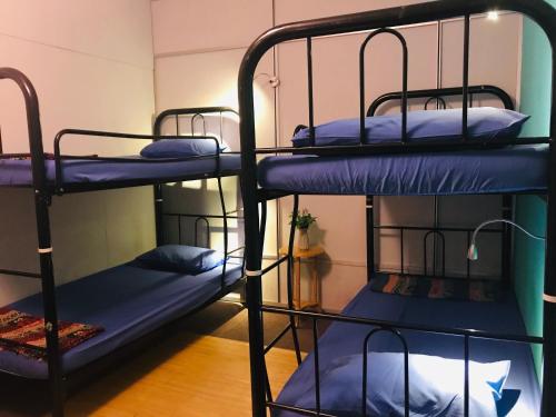 a group of bunk beds in a room at Borneo Sweet Guesthouse in Kuching