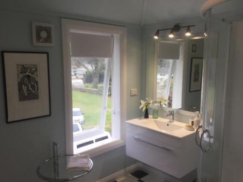 a bathroom with a sink and a window at The Inn At The Convent in Taumarunui