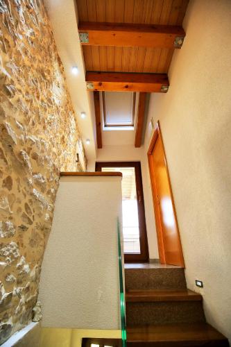an empty room with stairs and a stone wall at Julijana in Zadar