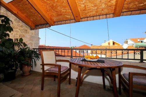 a table and chairs on a balcony with a view at Julijana in Zadar