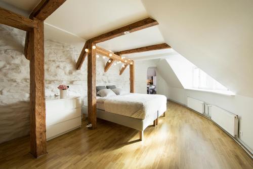 a bedroom with a large bed and wooden beams at Heaven Apartment in Tallinn