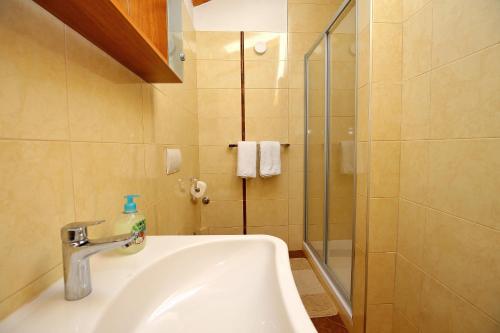 a bathroom with a sink and a shower at Julijana in Zadar