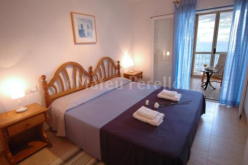 a bedroom with a bed with two towels on it at Casa Calma in Son Serra de Marina