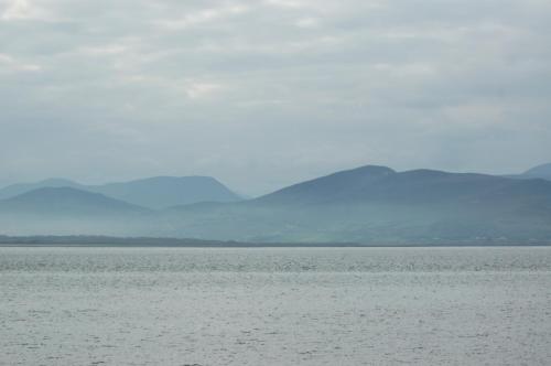 a large body of water with mountains in the background at The Grove Lodge Guesthouse in Killorglin