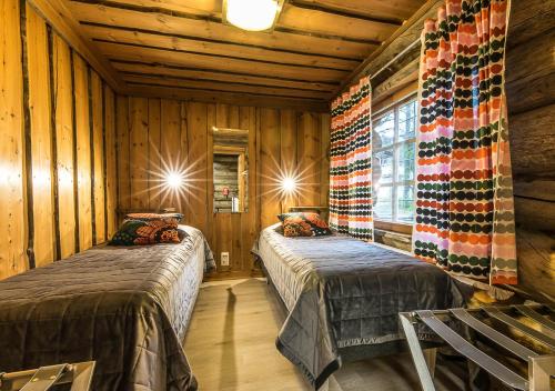 Postel nebo postele na pokoji v ubytování Levikaira Apartments - Log Cabins