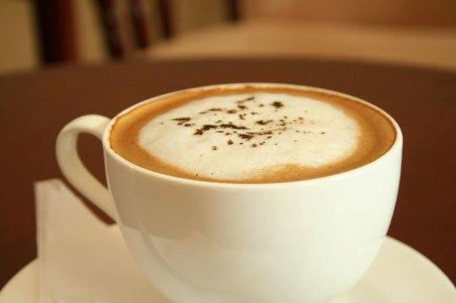 a cup of coffee sitting on a table at Moba Hotel & Convention Centre in Kitwe