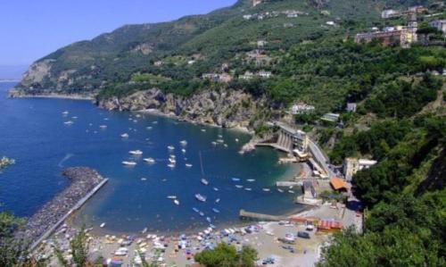 a view of a beach with boats in the water at Hill Valley View in Vico Equense