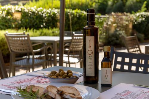 a table with a bottle of wine and a plate of bread at Olivium in La Spezia