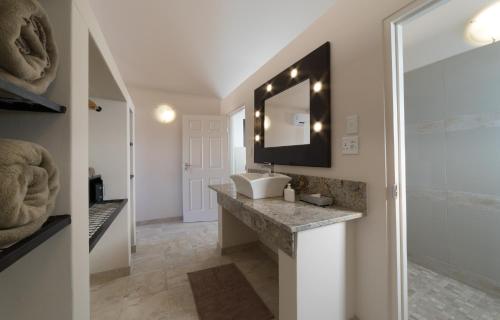 a bathroom with a sink and a mirror at Desert Camp in Sesriem