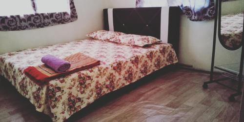 a bedroom with a bed with a wooden floor at Sarifah homestay in Melaka