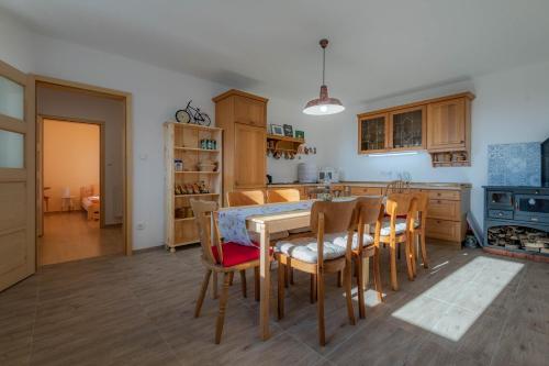 cocina con mesa y sillas y cocina con fogones en Včelařství pod svatým Floriánem, en Znojmo