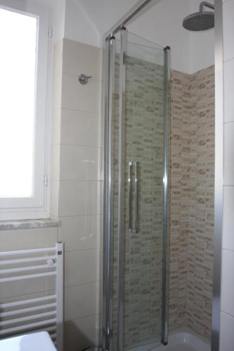 a shower with a glass door in a bathroom at Villa della Tartaruga in Casal Palocco