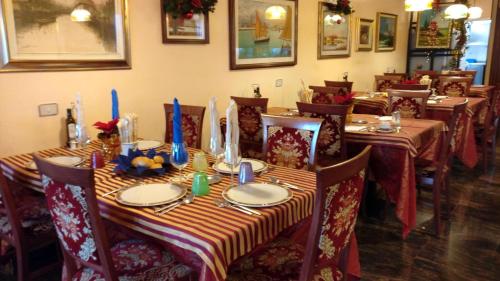 a dining room with tables and chairs with candles on them at Albergo Ristorante Fabrizio in Caorle
