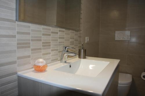 a white sink in a bathroom with a mirror at Villa della Tartaruga in Casal Palocco