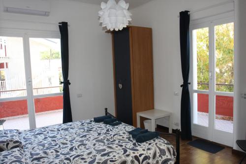 a bedroom with a bed and a large window at Villa della Tartaruga in Casal Palocco
