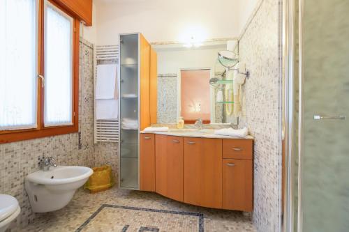 a bathroom with a sink and a toilet and a shower at Albergo Ristorante Fabrizio in Caorle