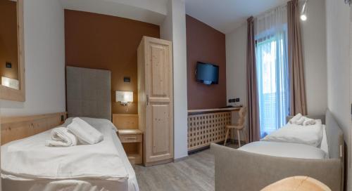 Postel nebo postele na pokoji v ubytování Hotel Garni My Ledro