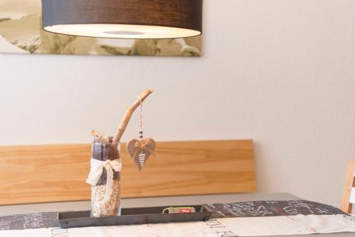 佩特诺伊阿尔贝格Apart Bellevue的坐在桌子上的带灯的花瓶