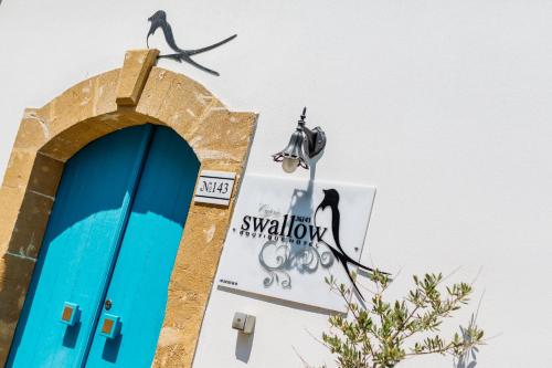 a sign on the side of a building with a bird at Cypriot Swallow Boutique Hotel in North Nicosia