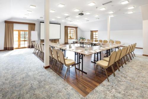 a large conference room with a long table and chairs at Dolina Charlotty Resort&Spa in Słupsk