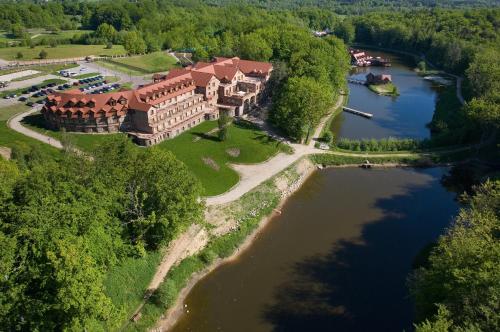 an aerial view of a mansion on a river at Dolina Charlotty Resort&Spa in Słupsk