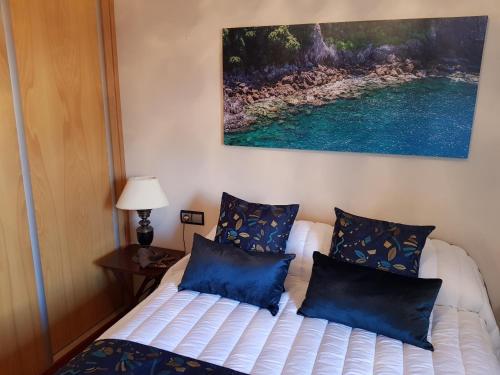 a bedroom with two beds with blue pillows at casazul in San Pedro