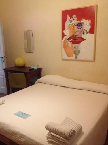 a bed in a room with a painting on the wall at Alloggio della Villetta in Palazzolo sullʼOglio